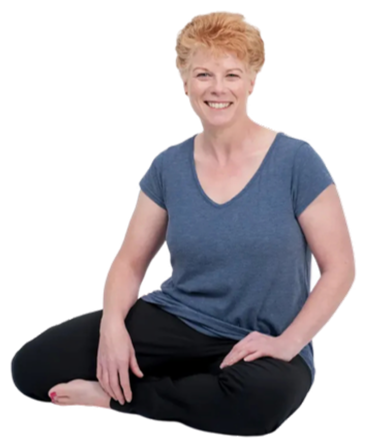 Tania Huddart sitting cross-legged on the floor, smiling